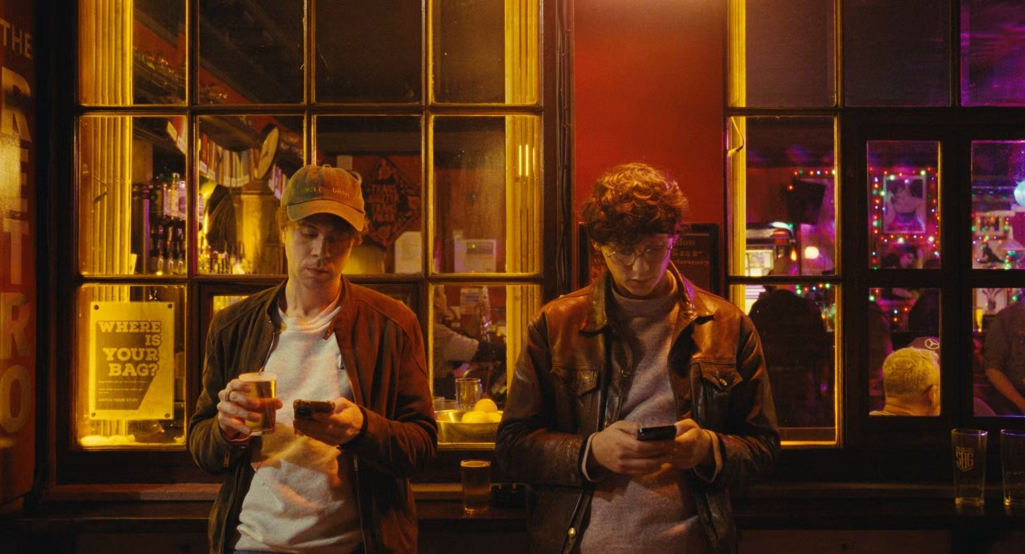 Two men outside a pub at night, from All Included